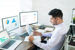 Junior Business Analyst reviewing data charts in a modern office